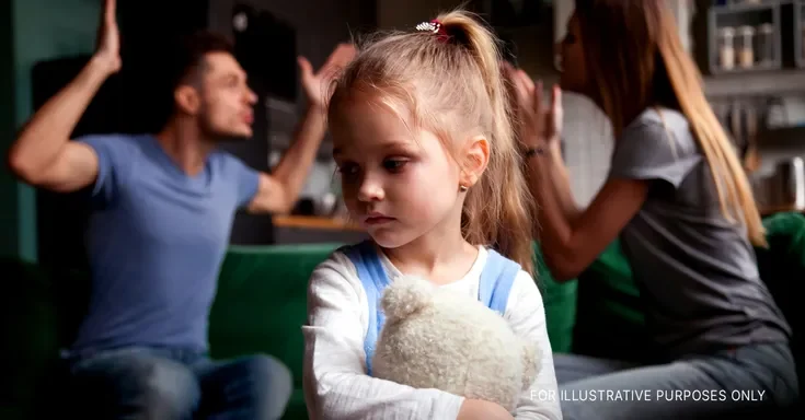 Girl feeling sad while her parents have an argument | Source: Shutterstock