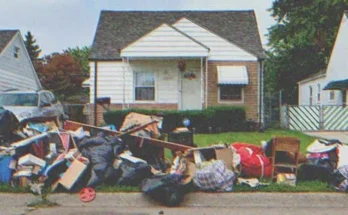 A pile of garbage in front of a house | Source: Shutterstock