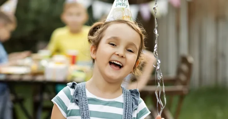 A happy child at her birthday party | Source: Shutterstock