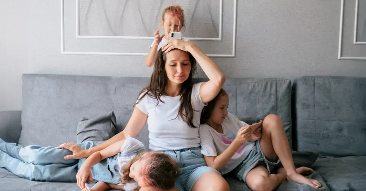 A mother with her three kids | Source: Shutterstock