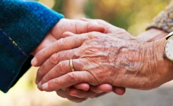 Elderly people holding hands | Source: Shutterstock