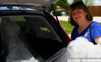 An elderly woman taking out a bridal dress from her car's trunk | Source: Flickr/waitscm/CC BY 2.0