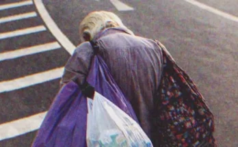 An old poor man walking down the street | Source: Shutterstock