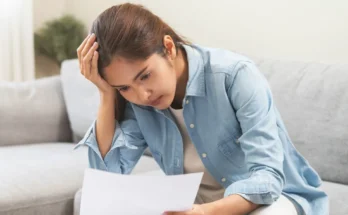 A woman looking at a document | Source: Shutterstock