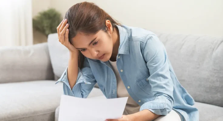 A woman looking at a document | Source: Shutterstock