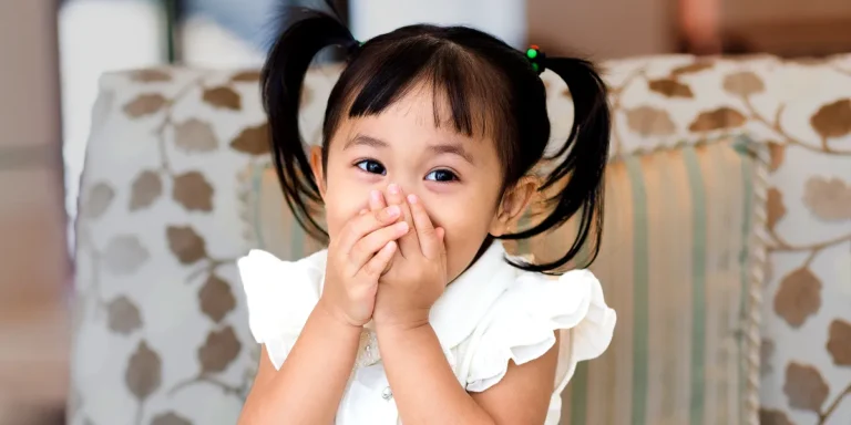 A girl sitting with her face covered | Source: Shutterstock