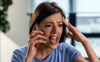 A shocked woman speaking on her phone | Source: Shutterstock