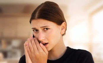 A young woman speaking secretively on her phone | Source: Shutterstock