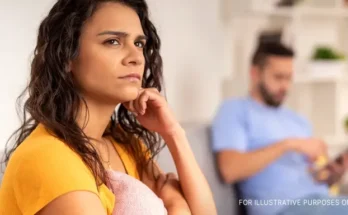 A serious woman lost in her thoughts while sitting next to her partner | Source: Shutterstock