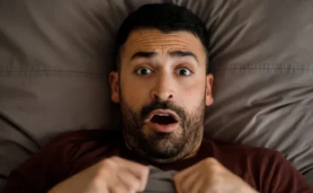 A shocked man in bed | Source: Shutterstock