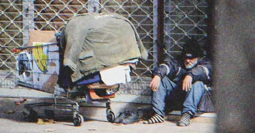 A homeless man sitting on the street | Source: Shutterstock