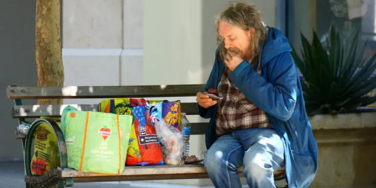 A homeless man eating food | Source: Shutterstock