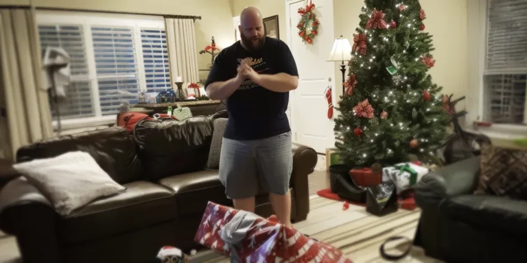 A man standing in a festive living room decorated for Christmas | Source: Amomama