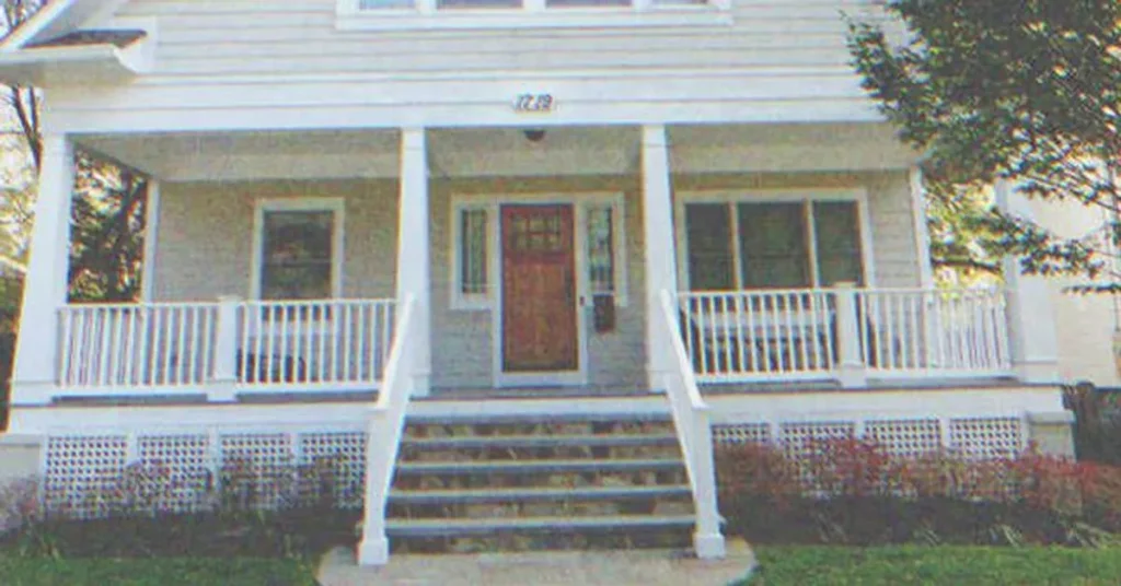 A white house with a porch | Source: