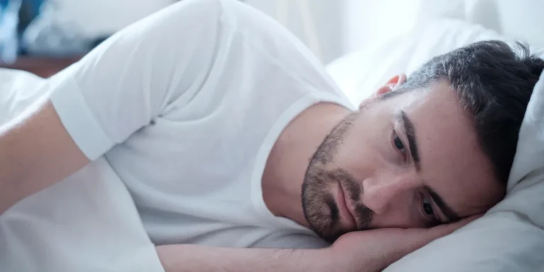 A man lying in bed | Source: Shutterstock