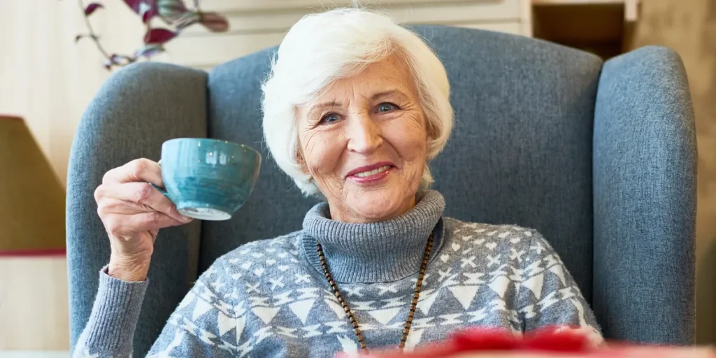 An older woman having a beverage | Source: Shutterstock