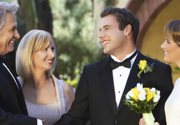 A bride and groom with an older couple | Source: Shutterstock