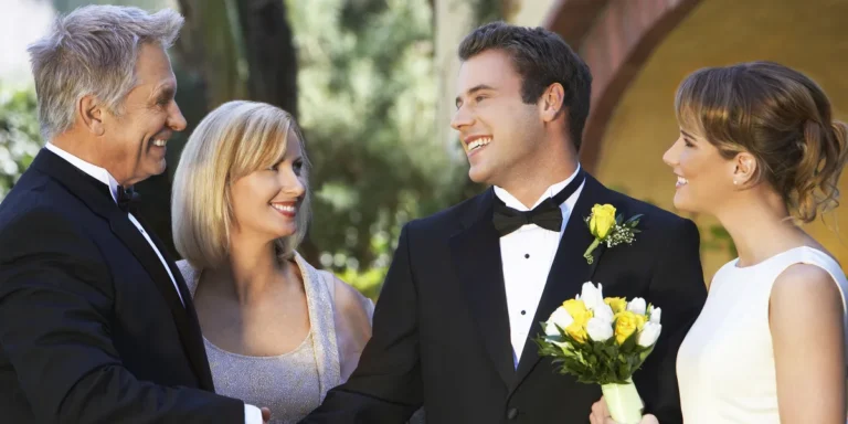 A bride and groom with an older couple | Source: Shutterstock