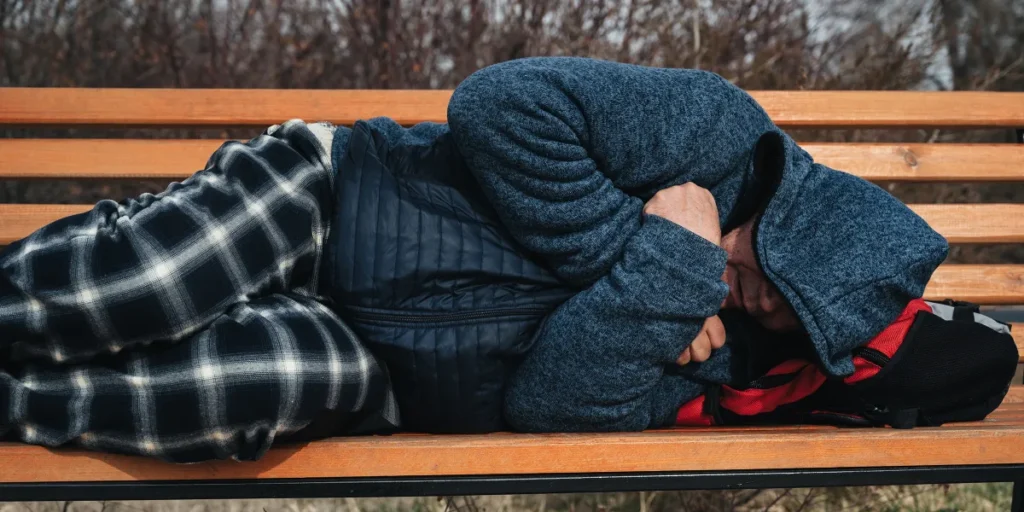 A man sleeping on a bench | Source: Shutterstock